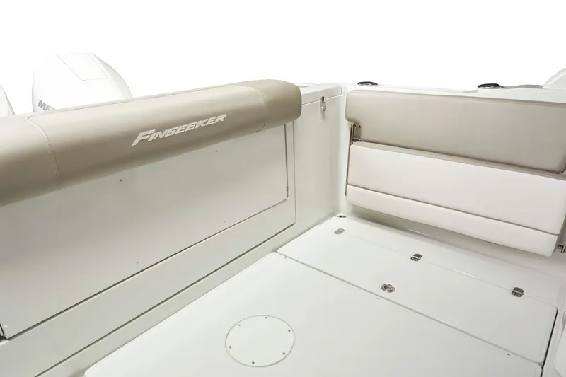 Slide: The Image of 2025 Finseeker 260 DC boat interior with beige seating and white deck. - 15