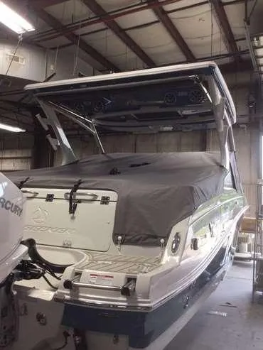 Slide: The Image of 2025 Finseeker 260 DC boat in a warehouse, covered and ready for storage. - 2