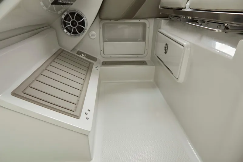 Slide: The Image of 2025 Finseeker 260 DC boat interior with storage compartments and speaker system. - 3