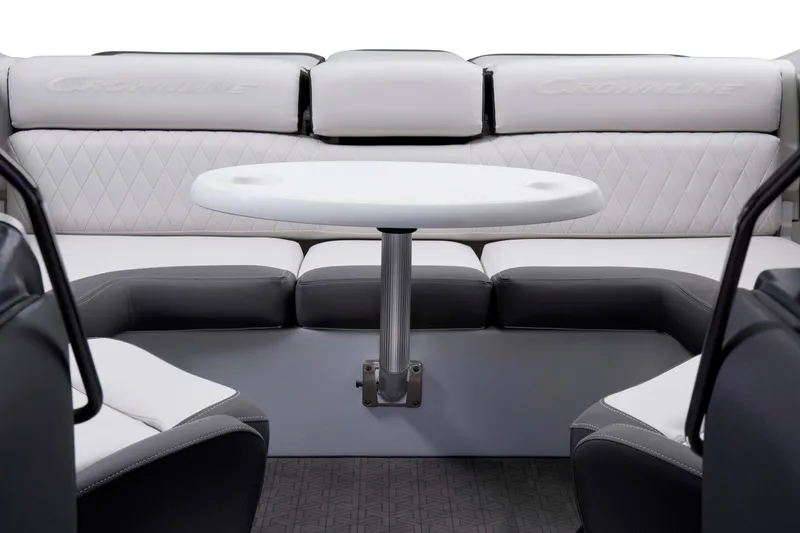 Slide: The Image of 2024 Crownline 240 SS LPX boat interior with white and gray seating and a central table. - 2