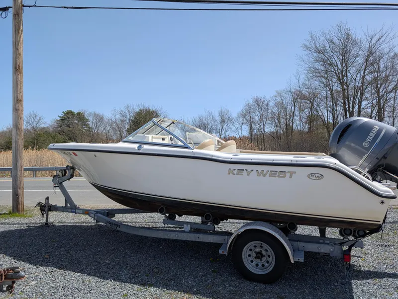 Slide: The Image of 2017 Key West 203 DFS boat on trailer, parked outdoors. - 0
