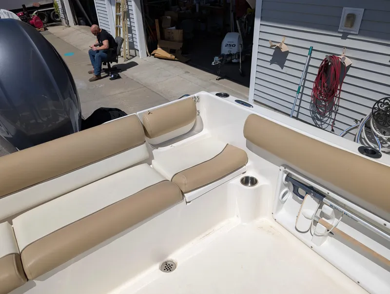 Slide: The Image of 2017 Key West 203 DFS boat interior with beige seating and storage area. - 12