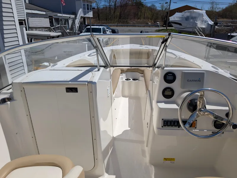 Slide: The Image of 2017 Key West 203 DFS boat interior with steering wheel and Garmin navigation system. - 16
