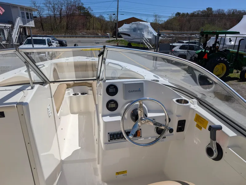 Slide: The Image of 2017 Key West 203 DFS boat interior with steering wheel and dashboard controls. - 17