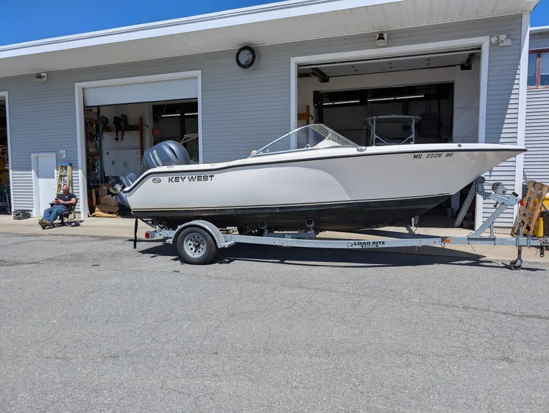Slide: The Image of 2017 Key West 203 DFS boat on trailer outside garage. - 2