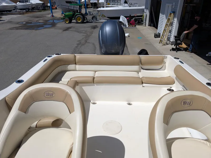 Slide: The Image of 2017 Key West 203 DFS boat interior with beige seating, docked at a marina. - 8