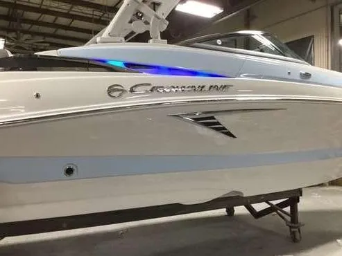 Slide: The Image of 2025 Crownline 260 XSS boat in showroom, featuring sleek design and modern detailing. - 4