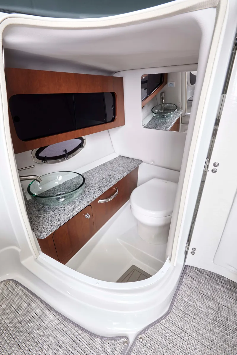 Slide: The Image of 2025 Crownline 290 XSS boat bathroom with modern sink and toilet. - 4