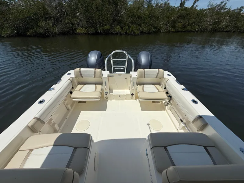 Slide: The Image of 2015 World Cat 255 DC boat interior with seating, on calm water. - 11