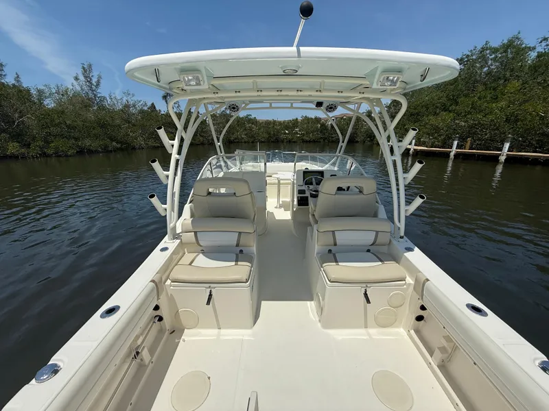 Slide: The Image of 2015 World Cat 255 DC boat interior with seating, on calm water. - 12