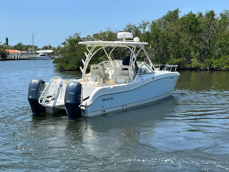 Slide: The Image of 2015 World Cat 255 DC boat on calm water, featuring dual engines and sleek design. - 7