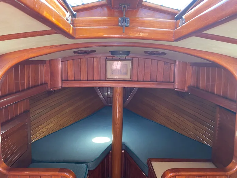 Slide: The Image of 1988 Custom Aft Cockpit interior with wooden finish and cozy sleeping area. - 10