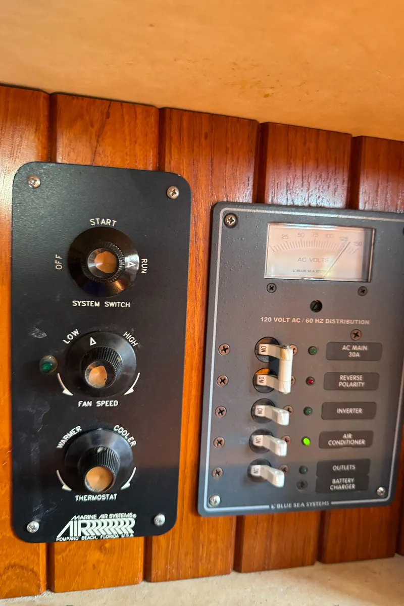 Slide: The Image of Control panel of a 1988 Custom Aft Cockpit boat with switches and dials. - 15