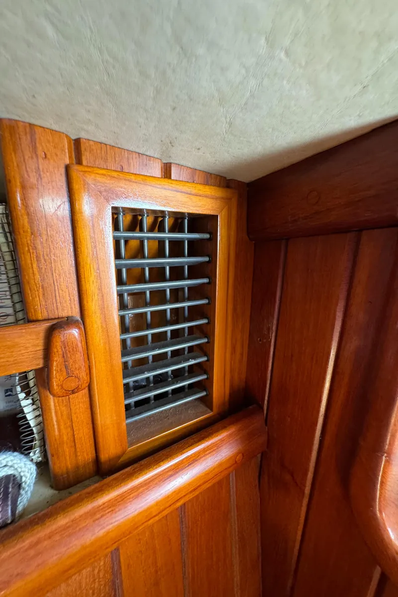 Slide: The Image of Wooden interior of a 1988 Custom Aft Cockpit boat with vented panel. - 16