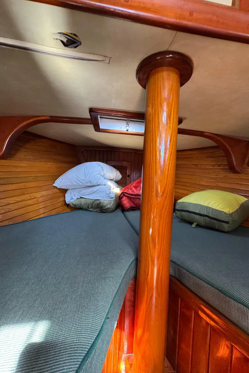 Slide: The Image of 1988 Custom Aft Cockpit interior with wooden finish and cozy bedding. - 17