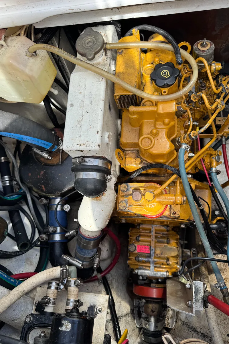 Slide: The Image of 1988 Custom Aft Cockpit engine compartment with yellow machinery and various hoses. - 20