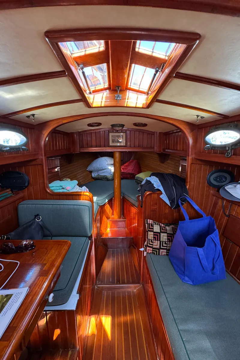 Slide: The Image of Interior of 1988 Custom Aft Cockpit boat with wooden finish and seating area. - 26