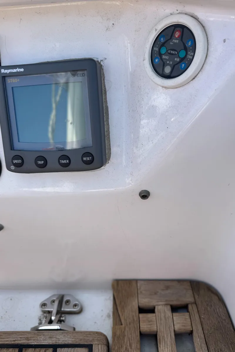 Slide: The Image of 1988 Custom Aft Cockpit boat dashboard with Raymarine display and control panel. - 28