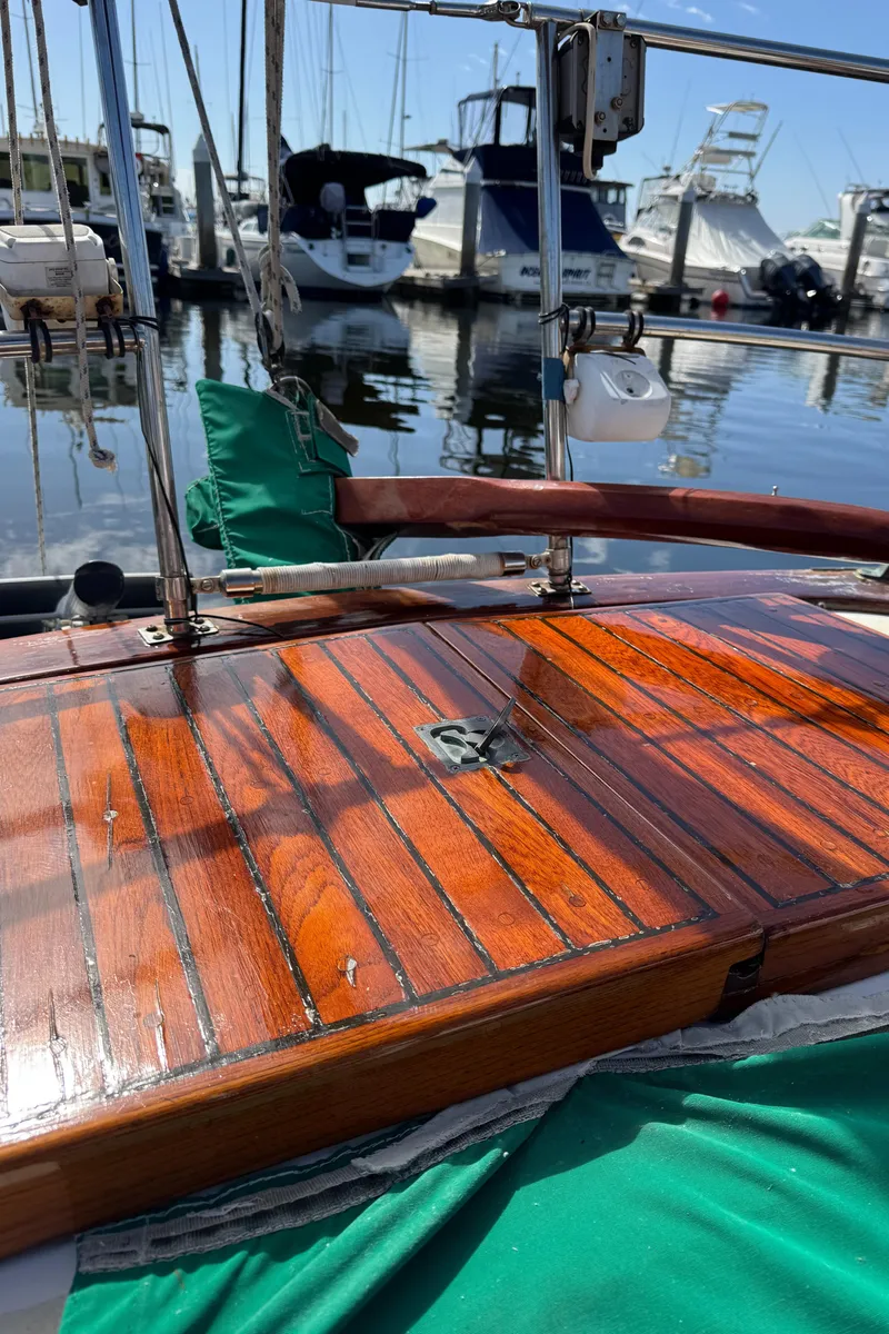 Slide: The Image of 1988 Custom Aft Cockpit sailboat with polished wooden deck at marina. - 30