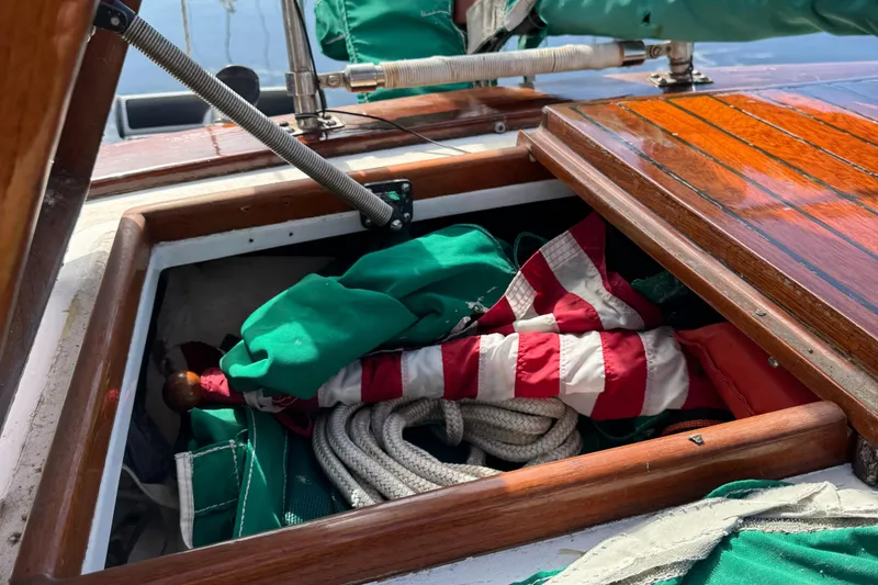 Slide: The Image of Open storage compartment on 1988 Custom Aft Cockpit boat with ropes and flag. - 31
