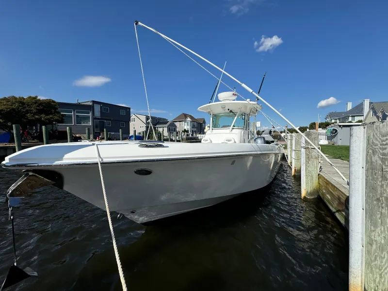 The Image of 2011 Everglades 325 Center Console boat docked on a sunny day. - 0