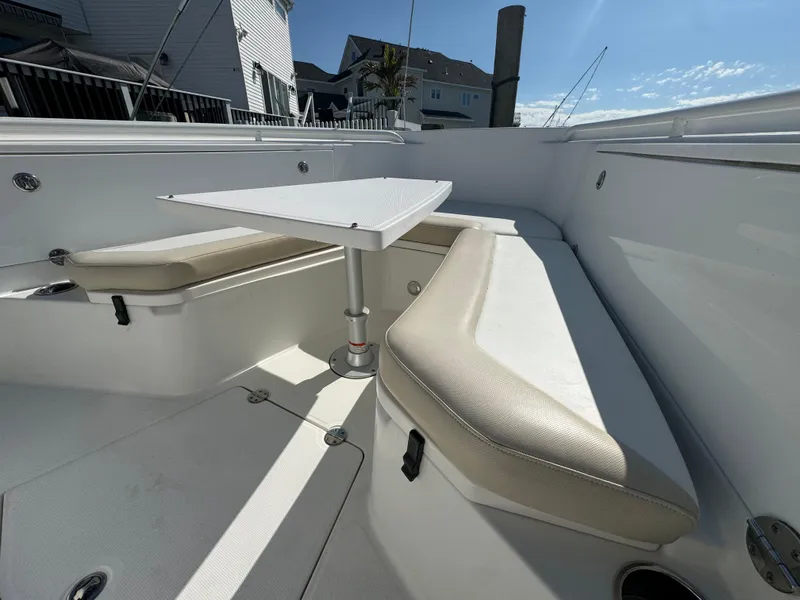 Slide: The Image of 2011 Everglades 325 Center Console boat interior with seating and table. - 19