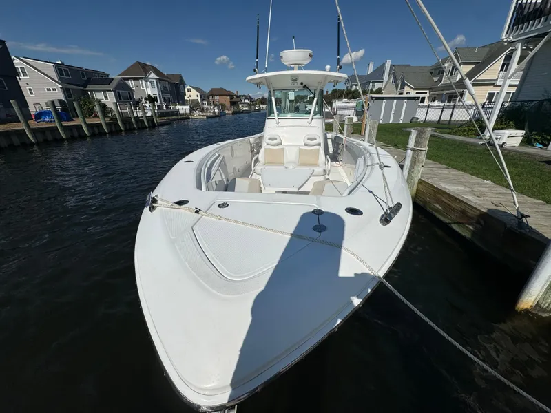 Slide: The Image of 2011 Everglades 325 Center Console boat docked in a residential canal. - 3