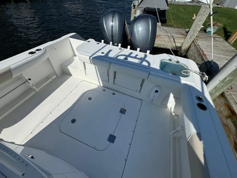 Slide: The Image of 2011 Everglades 325 Center Console boat with spacious deck and dual outboard motors. - 6