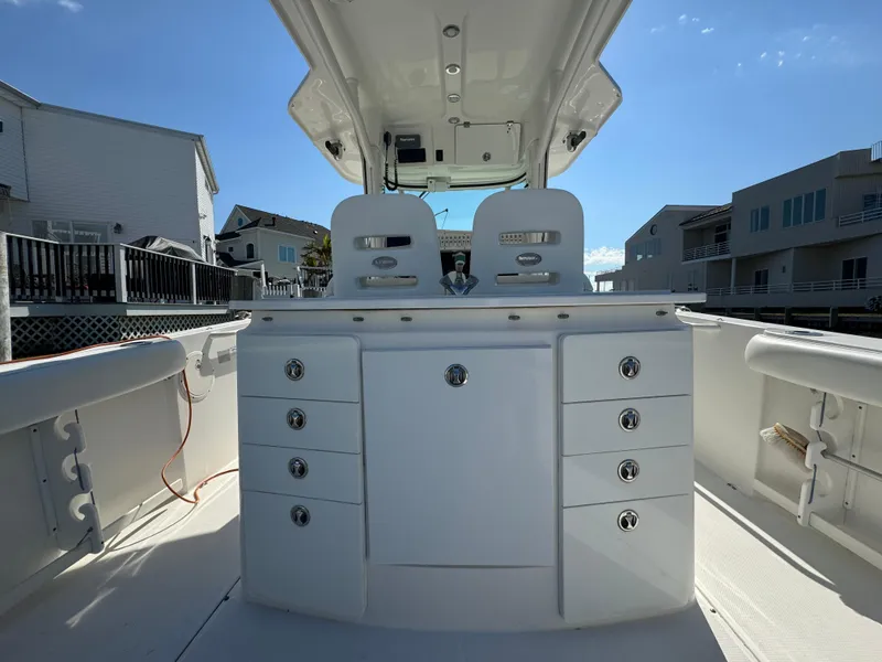 Slide: The Image of 2011 Everglades 325 Center Console boat interior with storage compartments and seating. - 8