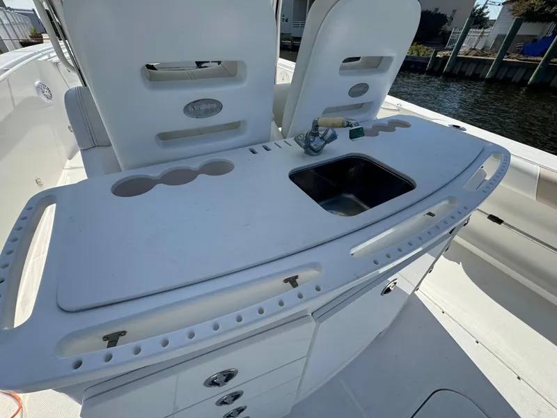 Slide: The Image of 2011 Everglades 325 Center Console boat with sink and storage on deck. - 9