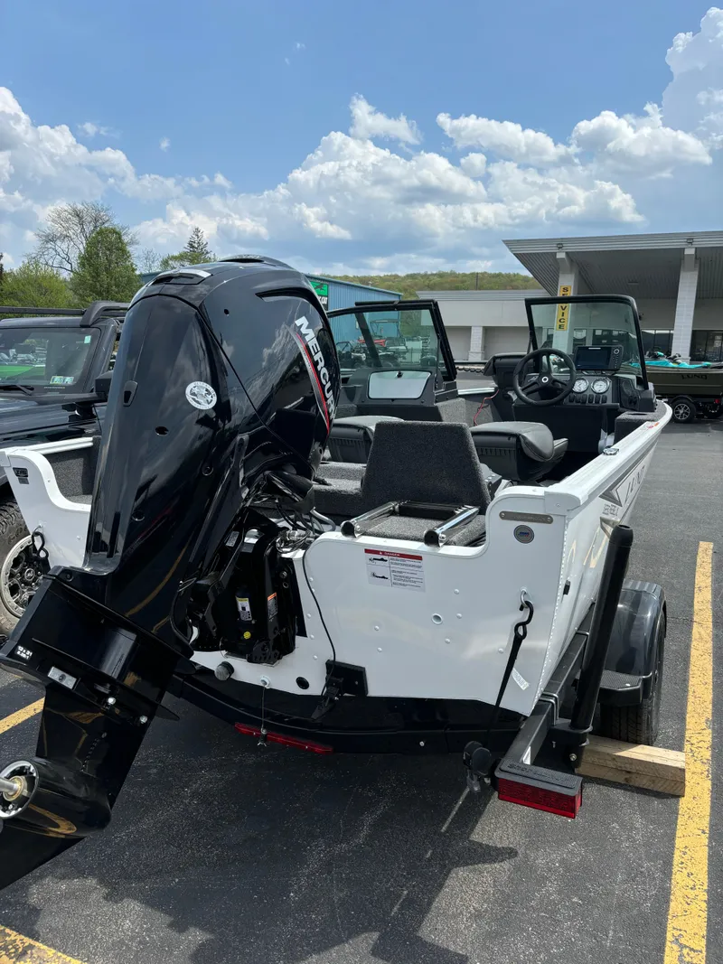 Slide: The Image of 2025 Lund 1650 Rebel XL Sport boat with outboard motor in parking lot. - 3