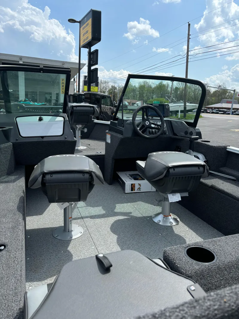 Slide: The Image of 2025 Lund 1650 Rebel XL Sport boat interior with seating and steering console. - 6