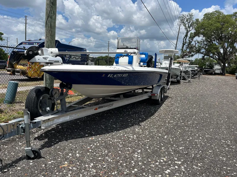 Slide: The Image of 2017 ShearWater 23LTZ boat on trailer, parked outdoors under a partly cloudy sky. - 0