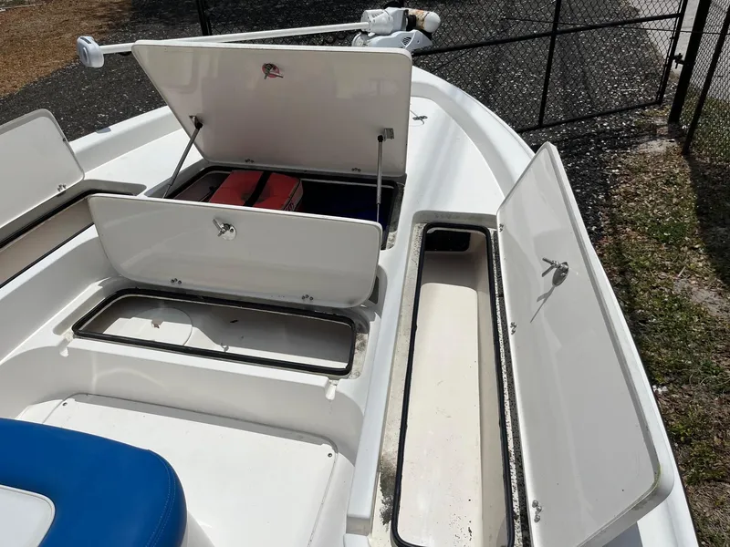 Slide: The Image of 2017 ShearWater 23LTZ boat storage compartments open, showcasing ample space and organization. - 14