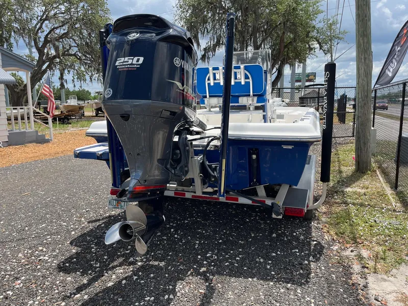 Slide: The Image of 2017 ShearWater 23LTZ boat with Yamaha 250 engine on a trailer, parked outdoors. - 6