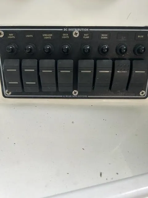 Slide: The Image of Control panel of a 2000 Regulator 23' Center Console boat with labeled switches. - 10