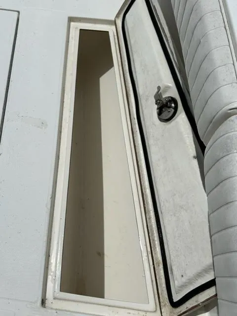 Slide: The Image of Open storage compartment on a 2000 Regulator 23' Center Console boat. - 18