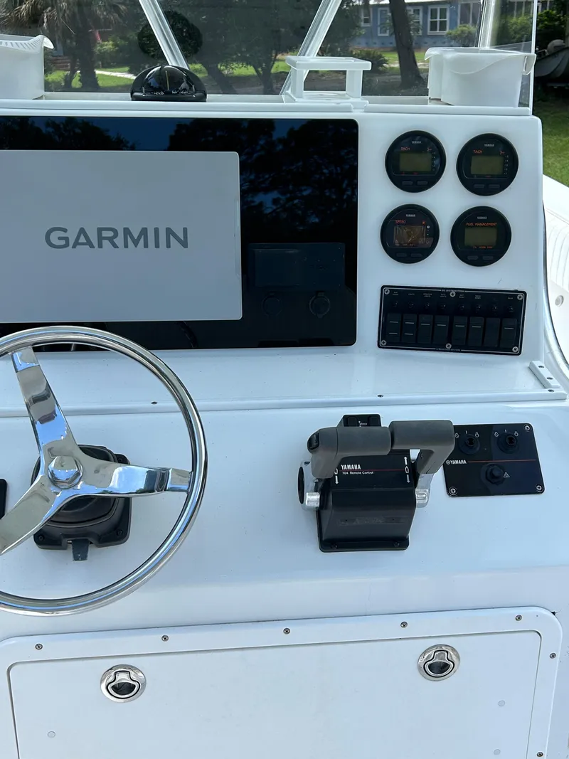 Slide: The Image of 2000 Regulator 23' Center Console dashboard with Garmin display and Yamaha controls. - 2