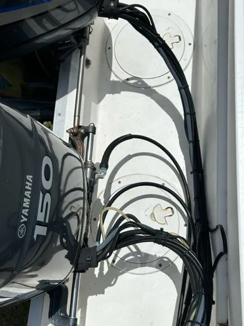 Slide: The Image of Yamaha 150 engine on 2000 Regulator 23' Center Console boat, showing wiring and components. - 22