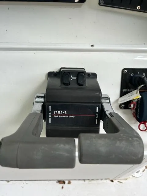 Slide: The Image of Yamaha 704 remote control on 2000 Regulator 23' Center Console boat dashboard. - 8