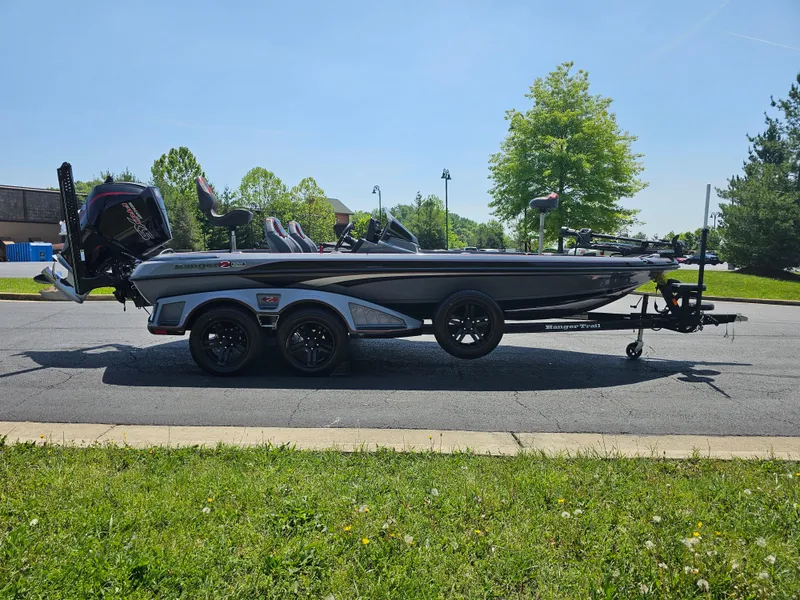 Slide: The Image of 2023 Ranger Z520R 55th Anniversary Limited Edition boat parked on a sunny street. - 2