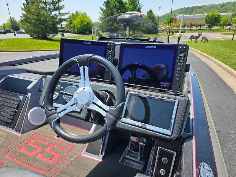 Slide: The Image of 2023 Ranger Z520R 55th Anniversary boat dashboard with advanced navigation screens and steering wheel. - 9