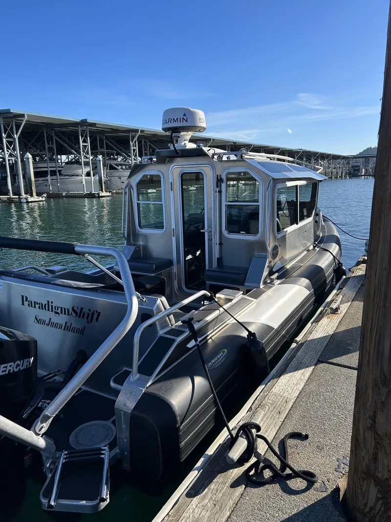Slide: The Image of 2021 Life Proof 25 Full Cabin boat docked at marina under clear blue sky. - 11