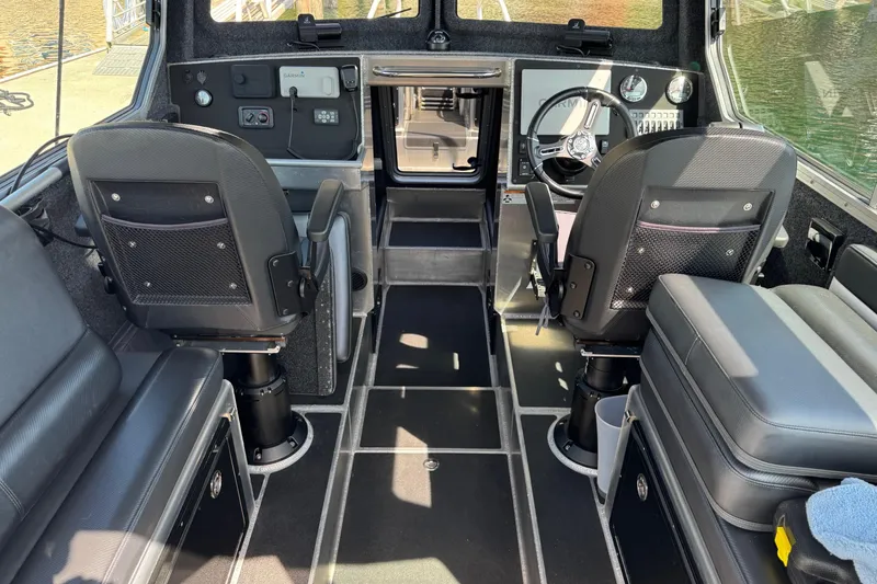 Slide: The Image of Interior of 2021 Life Proof 25 Full Cabin boat with modern seating and controls. - 13
