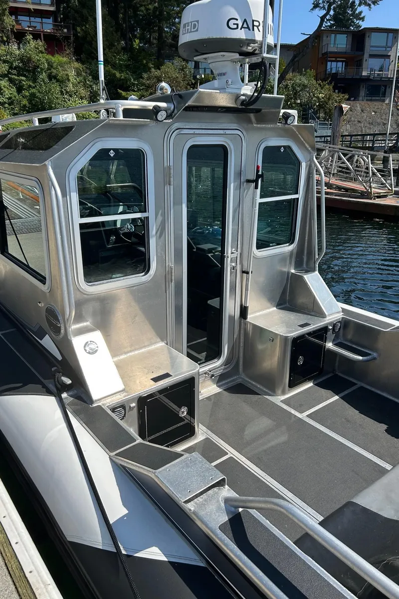 Slide: The Image of 2021 Life Proof 25 Full Cabin boat docked, featuring sleek design and modern equipment. - 14