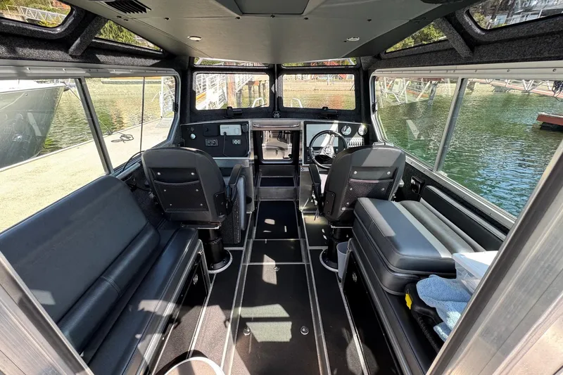 Slide: The Image of Interior of 2021 Life Proof 25 Full Cabin boat with seating and steering console. - 15