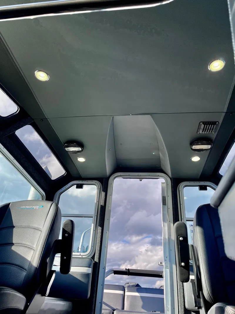 Slide: The Image of Interior of 2021 Life Proof 25 Full Cabin boat with modern seating and lighting. - 19