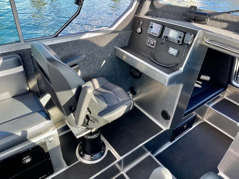 Slide: The Image of Interior of 2021 Life Proof 25 Full Cabin boat with control panel and seating. - 20