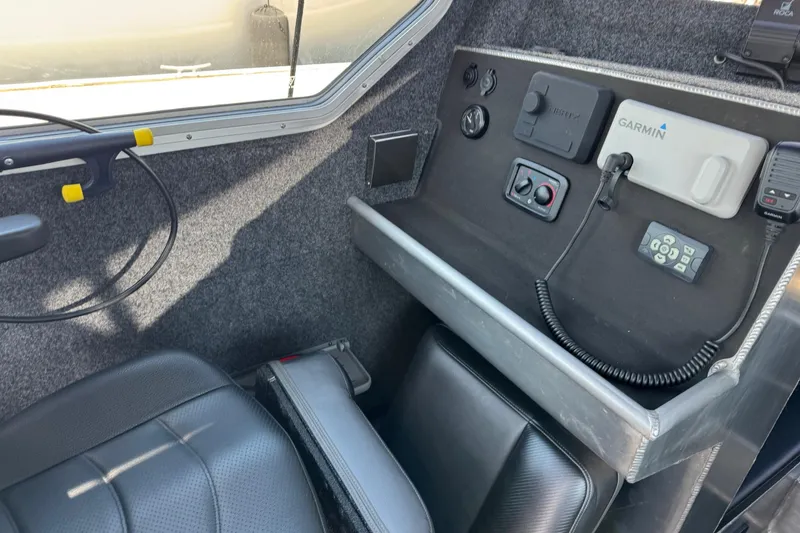 Slide: The Image of Interior of 2021 Life Proof 25 Full Cabin boat with control panel and seating. - 23