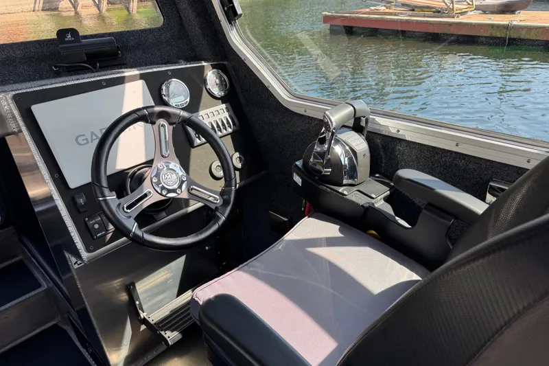 Slide: The Image of Interior of 2021 Life Proof 25 Full Cabin boat with steering wheel and controls. - 24